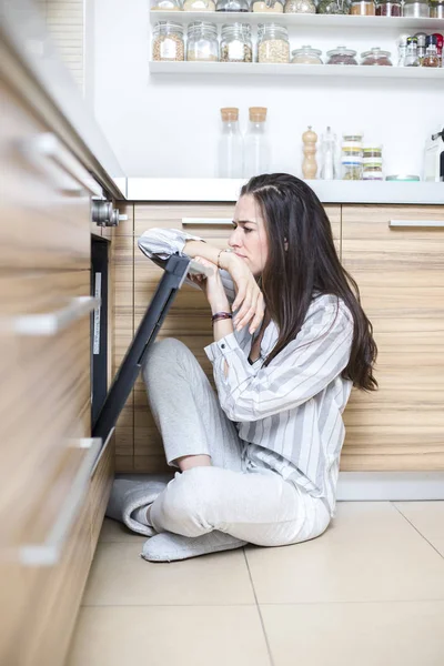 Wanita di dapur di depan oven mengekspresikan ketidakpuasan — Stok Foto