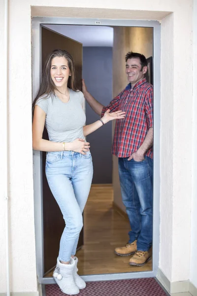 married couple at the front door of his apartment