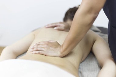 Spa salonunda masaj yaptıran bir kadın.