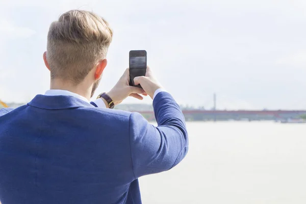 Uomo parlando foto sul lato del fiume — Foto Stock