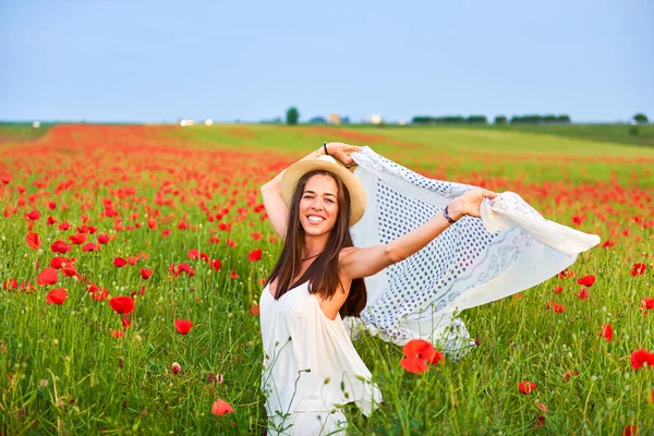 Woman in the field of red poppies — Stock Photo, Image