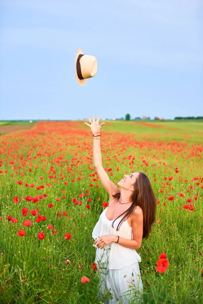 Woman in the field of red poppies — Stock Photo, Image