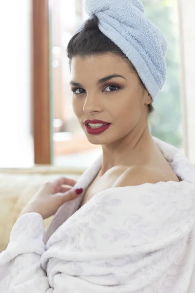 Beautiful woman in bathrobe wearing red lipstick