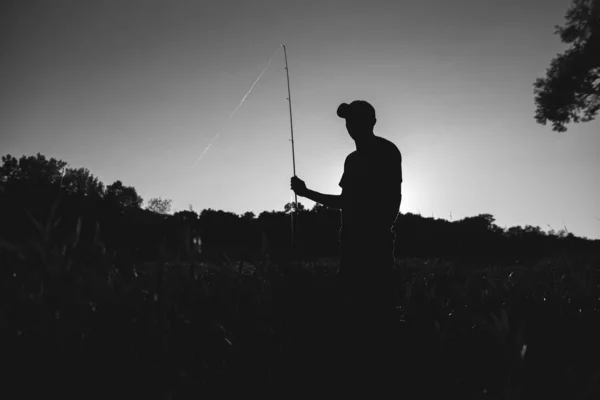 A fisher stands at his fishing spot on the White River in Indianapolis — Stock Photo, Image