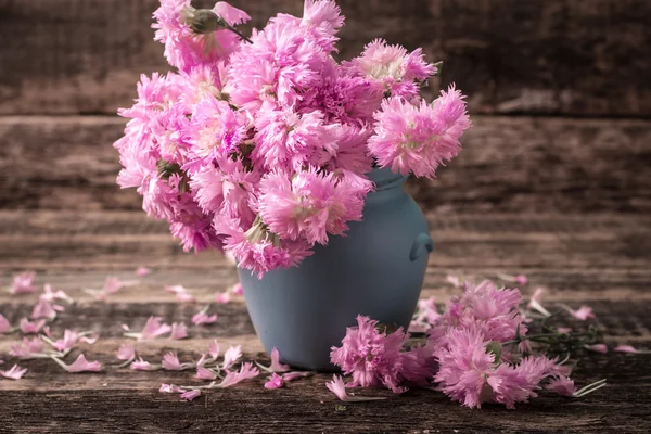 Fresh spring flowers on wooden vintage table — Stock Photo, Image