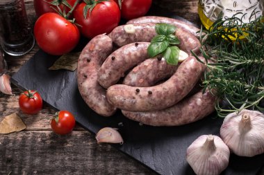 Taze kasap et ürün yelpazesine ahşap masa üzerinde taze biberiye ile süslenmiş kesmek