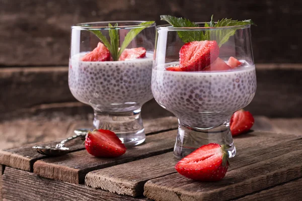 Chia tohum pudingi çilek ve ahşap antika arka plan üzerinde min