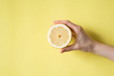 Limon sarı bir arka plan üzerinde kadının elinde