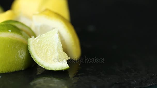 Närbild av kvinna hand skära citron på svart sten — Stockvideo