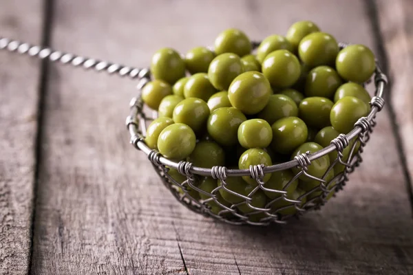 Guisantes verdes enlatados l sobre fondo de madera viejo, comida vegana saludable — Foto de Stock