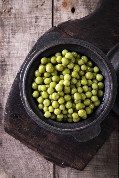 Guisantes verdes enlatados l sobre fondo de madera viejo, comida vegana saludable — Foto de Stock