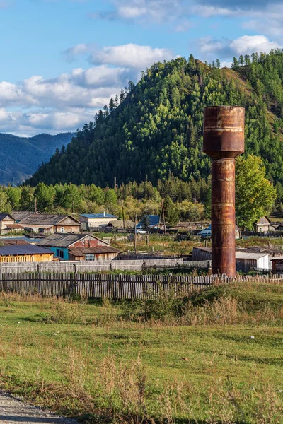 Water tower in a mountain village. Russia, mountain Altai, Ongudaysky district, picture taken in the village of Tuecta