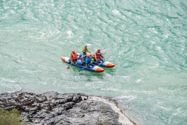 River Katun, Altai Republic, Russia - September 13, 2019: tourists-rafters rafting on mountain river