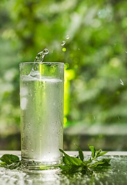 Serin temiz su buz ve nane ile. Splash cam. Sağlıklı yaşam konsepti