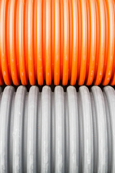 Construction tuyaux en plastique orange et noir — Photo