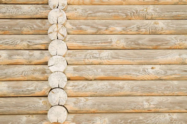 A wooden wall made of round logs — Stock Photo, Image