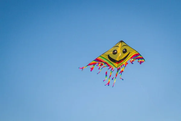 Fun and bright kite in the blue sky — Stock Photo, Image