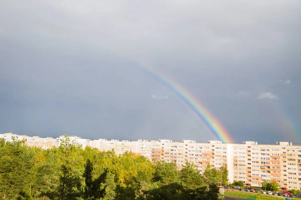 Un arco iris brillante sobre la ciudad en el otoño — Foto de Stock