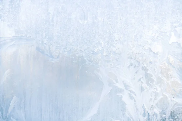 Winter frosty patterns on the frozen ice window — Stock Photo, Image