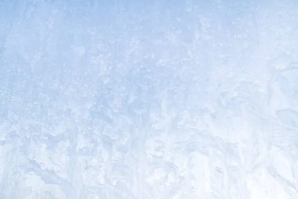 Winter frosty patterns on the frozen ice window