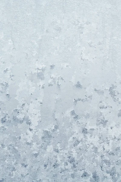 Winter frosty patterns on the frozen ice window