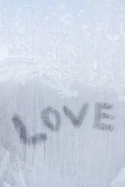 Inscrição de amor na janela congelada em padrões de inverno em Wint — Fotografia de Stock