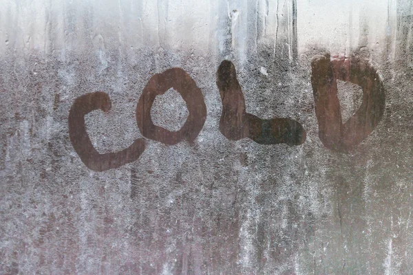 The inscription is cold on a frozen window with patterns