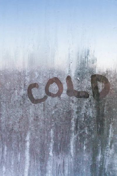 The inscription is cold on a frozen window with patterns