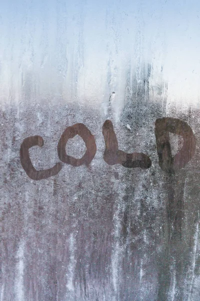 The inscription is cold on a frozen window with patterns