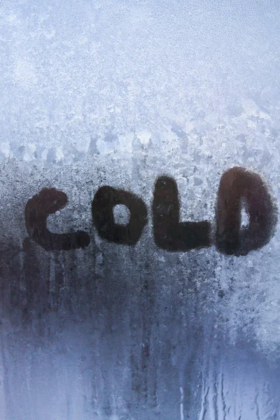 The inscription is cold on a frozen window with patterns