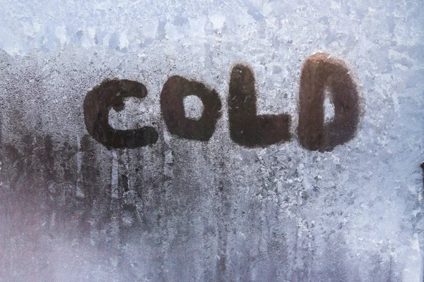 The inscription is cold on a frozen window with patterns