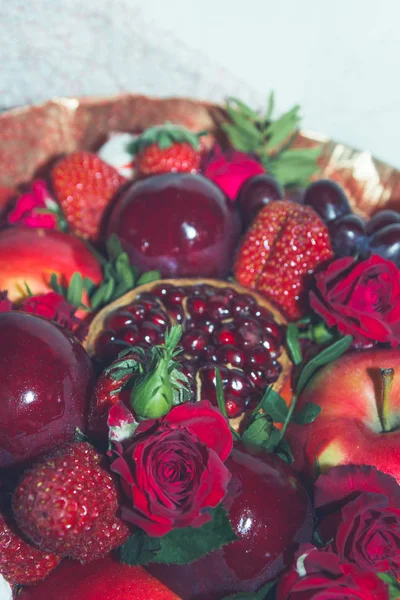 Bright red beautiful bouquet of fruits and flowers
