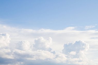 Büyük beyaz kümülüs bulutlar üzerinde mavi gökyüzü