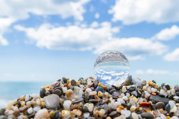 Glass round ball on the beach reflects the sea in summer — Stock Photo, Image