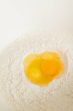 Cooking dough in a white plastic bowl at home