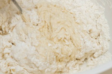 Cooking dough in a white plastic bowl at home