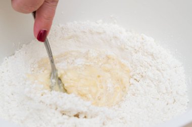 Cooking dough in a white plastic bowl at home