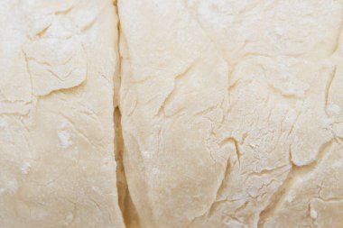 Prepared kneaded dough on a wooden table at home