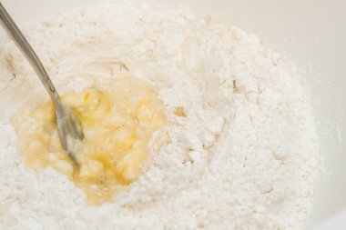Cooking dough in a white plastic bowl at home
