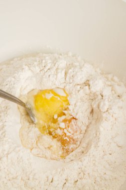 Cooking dough in a white plastic bowl at home