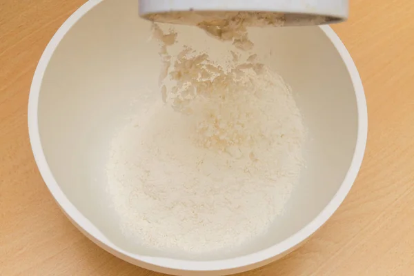 Cooking dough in a white plastic bowl at home — Stok fotoğraf