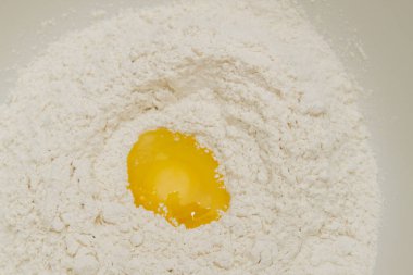 Cooking dough in a white plastic bowl at home