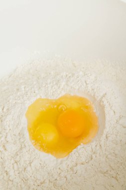 Cooking dough in a white plastic bowl at home