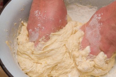 Cooking dough in a white plastic bowl at home