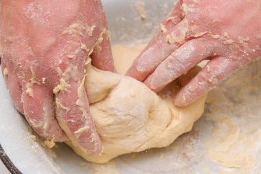 Cooking dough in a white plastic bowl at home