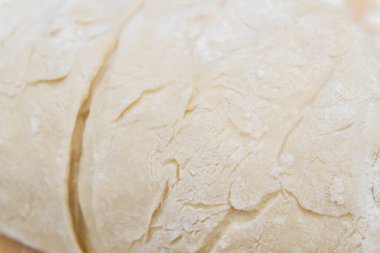 Prepared kneaded dough on a wooden table at home