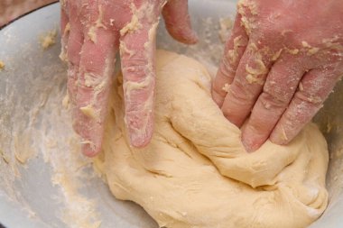 Cooking dough in a white plastic bowl at home