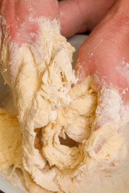 Cooking dough in a white plastic bowl at home
