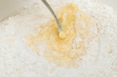 Cooking dough in a white plastic bowl at home