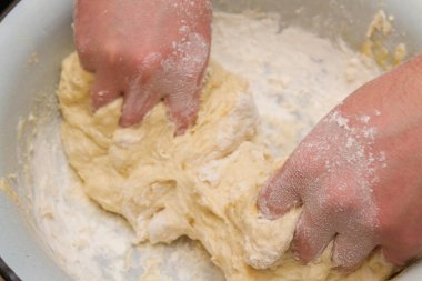 Cooking dough in a white plastic bowl at home